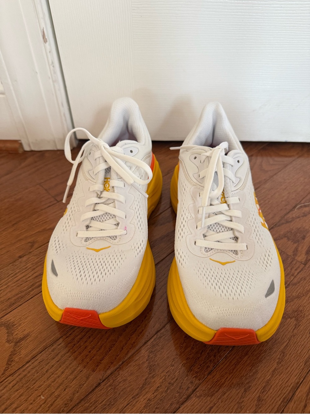 Women’s Hoka Bondi 9 White Running Shoes with Yellow Midsole and Orange Toe